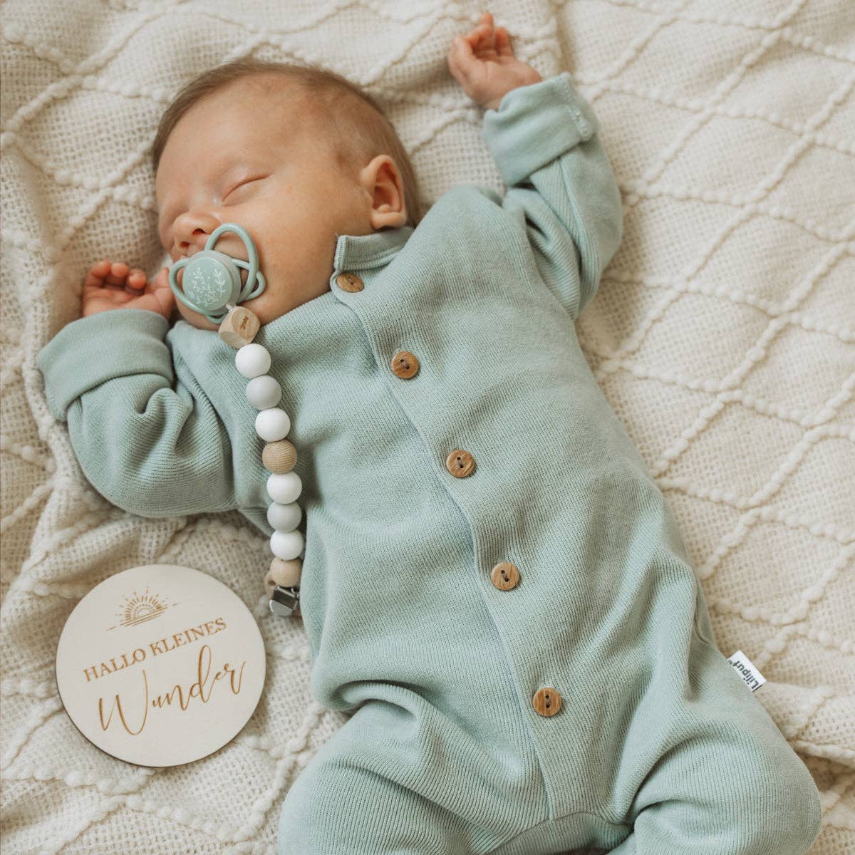 Baby Rib-Strick-Overall in Schilf, aus 80% Baumwolle und 20% Polyester, mit fünf Knöpfen in Holzoptik, umgeschlagene Säume, weich und bequem.