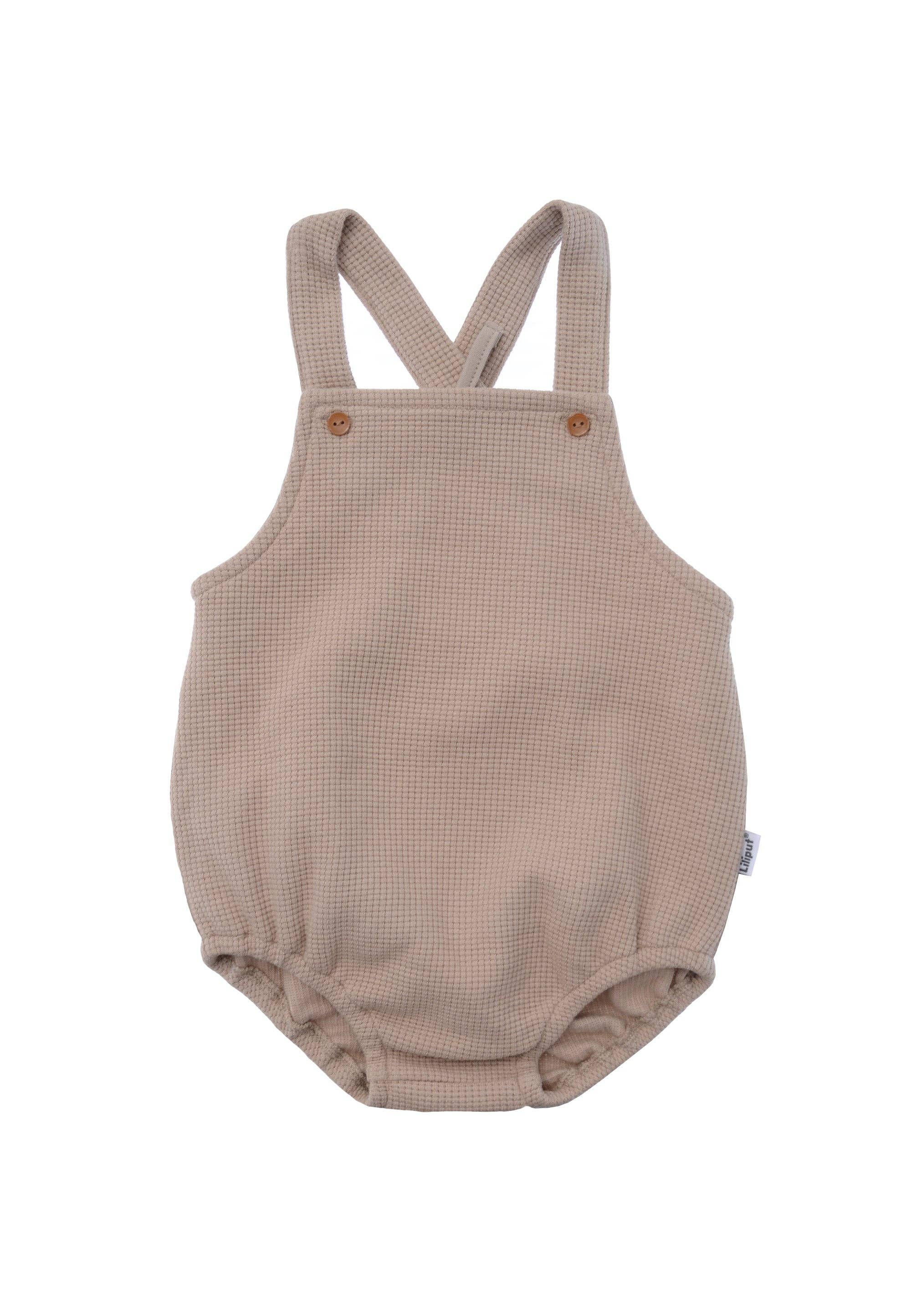 Beige Babylatzhose aus Waffel Piqué mit Trägern, bequemer Strampler für Babys, weich, strapazierfähig und stylisch, ideal für Alltag und besondere Anlässe.