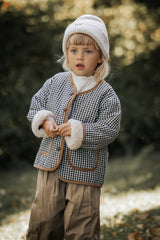 Wendejacke für Kinder aus flauschigem Teddyplüsch und weicher Baumwolle in Creme – warm, gemütlich und hautfreundlich.